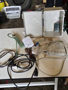 Assorted Electrical Components including APC Surge Protector, Power Strips, Extension Cords, and NEMA Enclosure