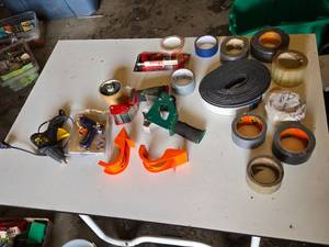 Assorted Tape and Adhesive Tools including Glue Guns, Tape Dispensers, and Plastic Mender