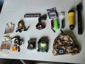 Lot of Flashlights and Headlamps Including Rechargeable LED Safety Lights, Black & Decker Work Light, and Accessories