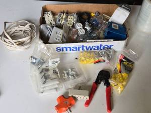 Box of Electrical Hardware and Tools including Wire Connectors, Electrical Outlets, and Crimping Tool