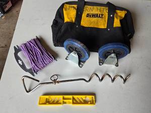 DeWalt Tool Bag and Accessories including Casters, Purple Rope, Tie Out Stake, and Small Level