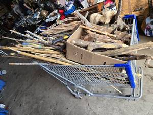 Shopping Cart full Sticks (some carved), Driftwood, and Hand Tools