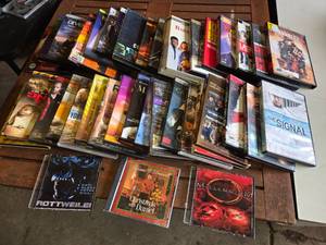 Collection of DVDs and CDs including Divergent, Spider-Man 2, and Christmas with Daniel