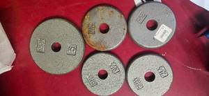 Lot of  four 2.5 LBS of one -inch weight plates and a 5lb plates ( USED)