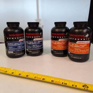 Lot of 4 1-pound containers of Winchester smokeless rifle powder, ideal for high-performance reloading.
