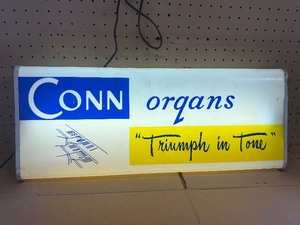This vintage sign features branding for Conn organs, a prominent manufacturer of electronic organs