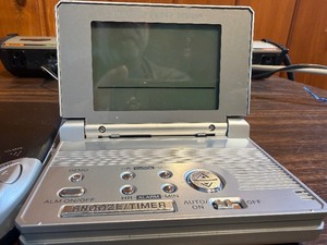 Sharper Image Design Travel Alarm plus RCA Disc player and ear phones.