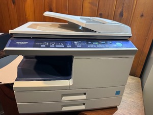 Sharp AL-2040CS desktop digital copierprinter powers on makes copies.