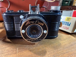 This vintage collectible is a Herold Acro-Flash bakelite miniature camera, manufactured by the Herold Manufacturing Company in Chicago, Illinois