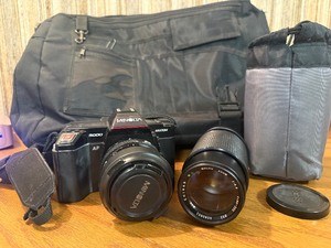Vintage Minolta Maxxum 5000, which is a 35mm single-lens reflex (SLR) film camera Plus extra lens and case