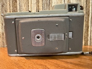 This item is a vintage Polaroid Land Camera, specifically identified as a Model 80 Highlander from the 1950s