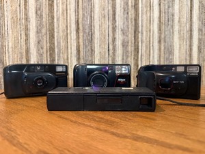 Vintage film cameras, including models from Vivitar, Nikon, and Canon.