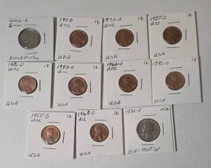 11- Coins  (9 Uncirculated Pennies and 1 Uncirculated Quarter) and ( 1 Error Nickel)