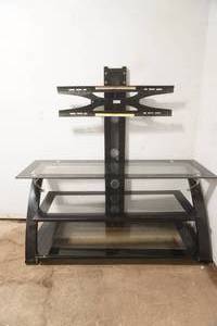TV Stand. black metal frame, tempered glass shelves, integrated swivel mount for flat screen TV. 50x 21x 52