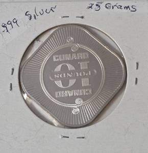 10 Pounds collectible token from the Cunard Line, specifically featuring the Queen Elizabeth 2 ocean liner. ( .999 Silver, 25 grams) - Lot 18
