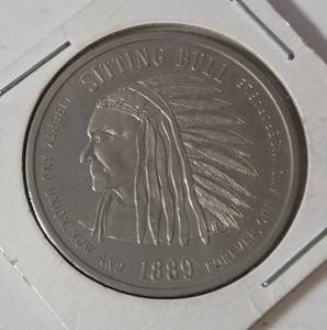 1889  ND Sitting Bull Souvenir Token.  Commemorates the year ND became a state. Featuring a portrait of Sitting Bull on the obverse and an American Seal on the Reverse.  - Lot 21