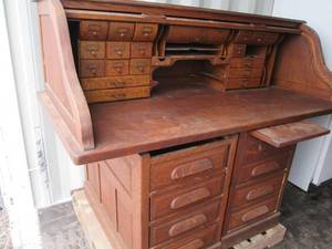 Antique rolltop desk with lots of s...