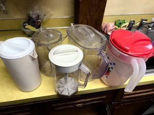 Assortment of pitchers with lids