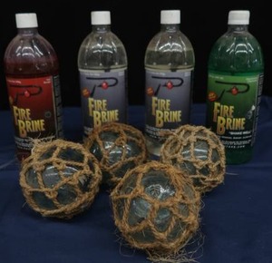 4 SMALL JAPENESE GLASS FISHING FLOATS, WITH 4 BOTTLES OF FIRE BRINE