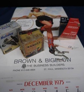 BROWN AND BIGELOW PIN UP CALENDER AND SHOTGUN AMMO