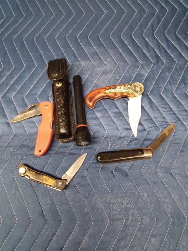 4 Pocket knives and a flashlight with case