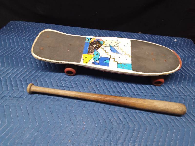 Skateboard and a wood baseball bat