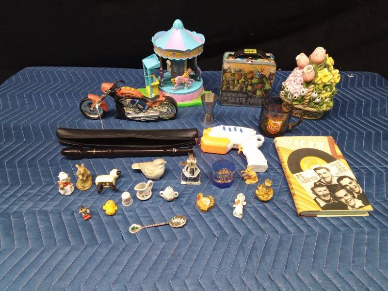 Box of collectibles including a jar of gold flakes, music recorder, and Ninja Turtle lunch box