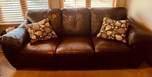 Brown Leather Sofa - 3-Seater with Floral Throw Pillows