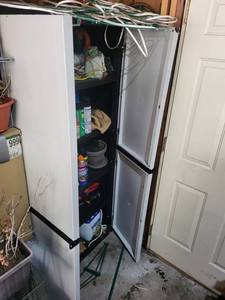 Tall Storage Cabinet With Assorted Garden Supplies