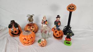 Assorted Halloween Decorations including Jack-o-Lanterns, Figurines, and Candle Holders