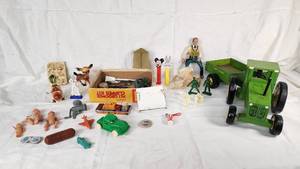 Assorted Toys and Collectibles Including John Deere Tractor, Action Figures, and Accessories