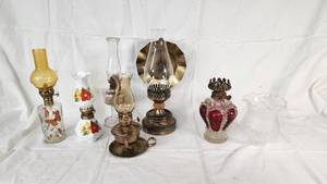 Collection of Vintage Oil Lamps with Colorful Glass and Metal Features