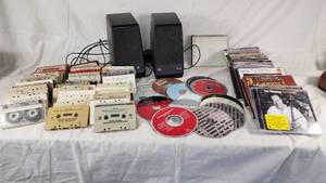 Collection of Cassette Tapes, CDs, and Speakers