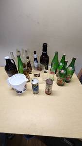 Collection of Vintage Beverage Bottles and Cans Including Miller, Schlitz, 7-Up, and Coca-Cola