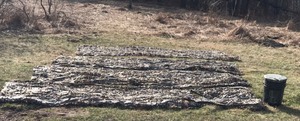 4 - Pieces of Camouflage Netting and 1 5 Gallon Pail with Padded Seat