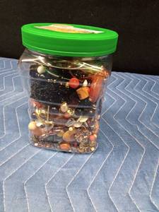 Jar of jewelry and jewelry pieces