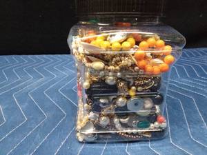 Jar of jewelry and jewelry pieces