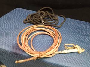 Paint sprayer hose with nozzle and a garden hose