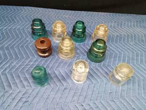 8 Glass insulators and 1 brown ceramic