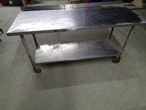 Stainless steel shop table on wheels with bottom shelf