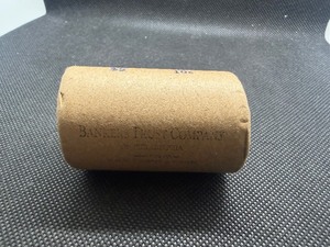 Unopened 20 coin roll of Morgan silver dollars with a high grade 1893 at one end and a high grade CC at the other end