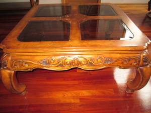 Ornate solid wood coffee table with glass top.  Add class and style to your living room with this quality furniture piece