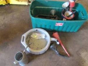 Tote filled with oil change pans and funnels