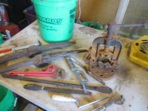 Bucket filled with vintage and antique tools