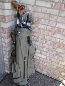 Golf clubs and balls in a golf bag...