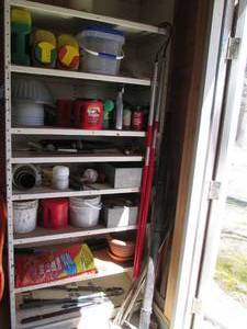 Metal Garage Shelf filled with gardening supplies, tools and more