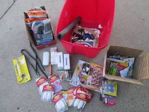Tote filled with hooks, weather stripping, home, bath and other supplies