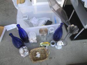 Tote of home decor including vases, shells and sand dollars, rugs and more