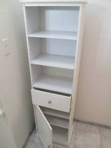 Tall slender shelf with a drawer