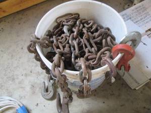 Bucket full of chains and spool of cable